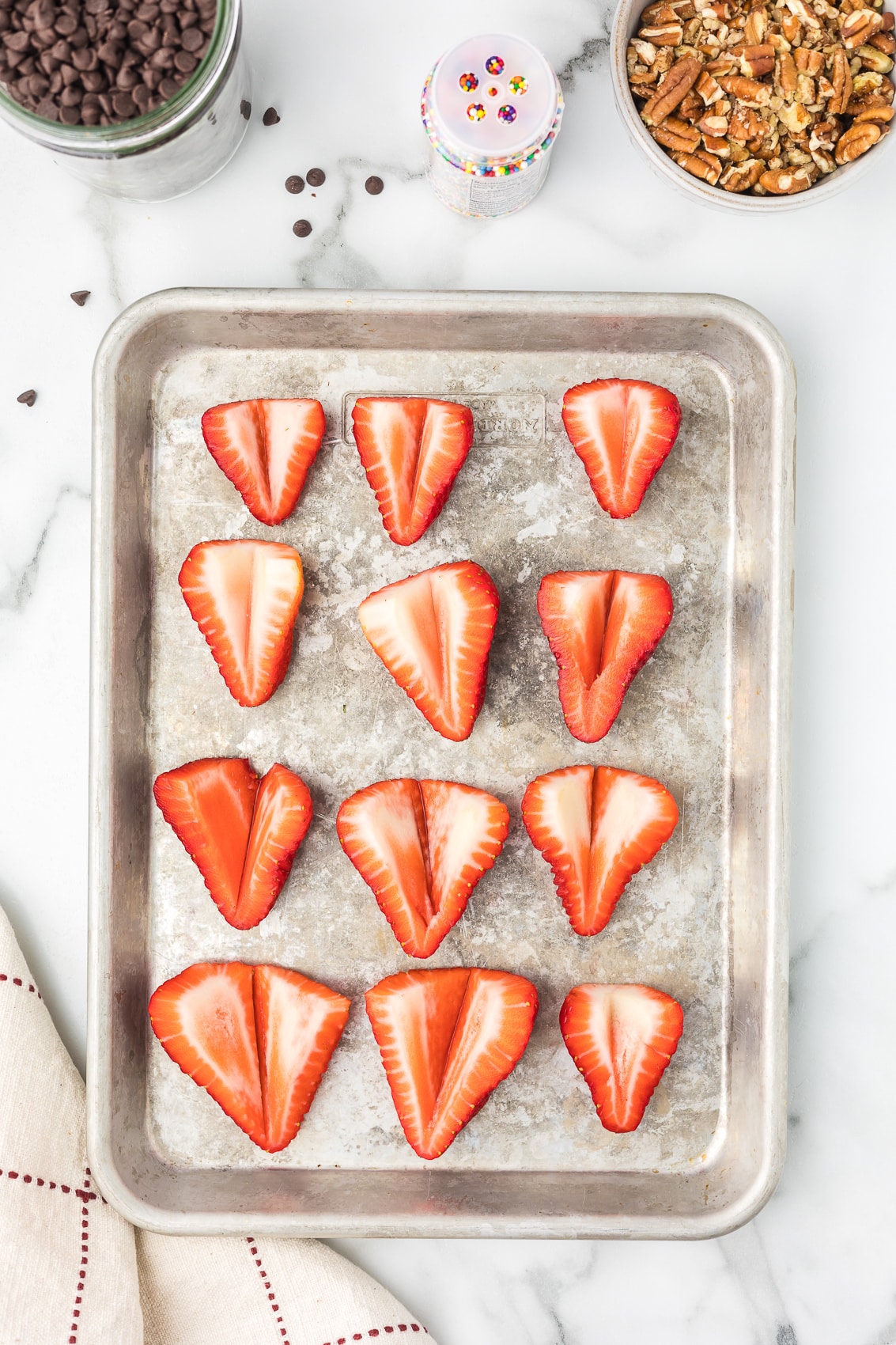 Strawberries cut in half with a small amount of the middle removed.