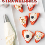 Deviled strawberries on a white serving dish with a piping bag next to it.