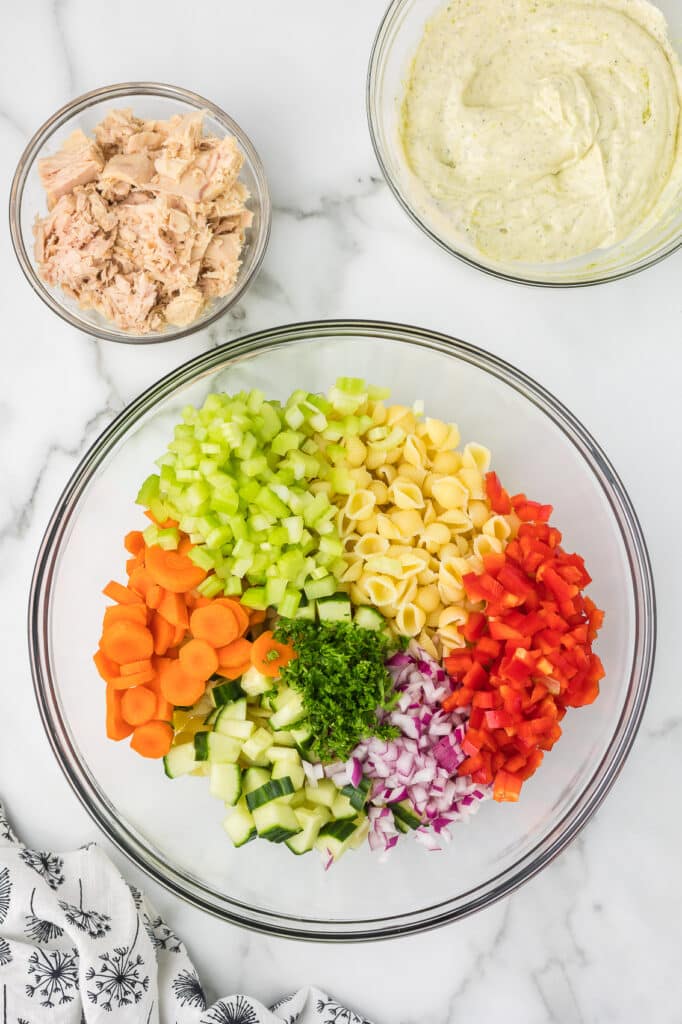 A bowl with all of the ingredients in a bowl before the tuna and dressing are added.