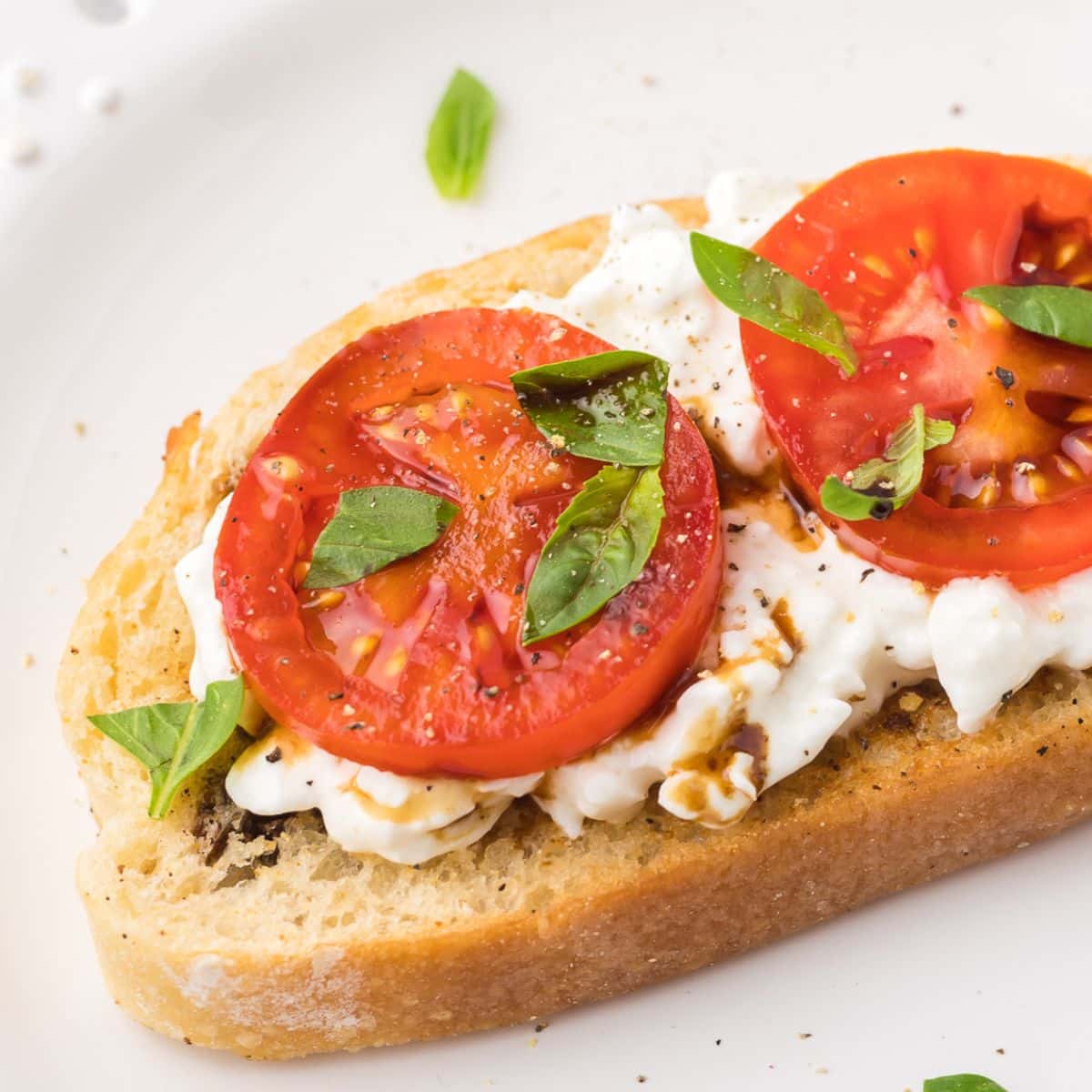 Cottage cheese toast with tomatoes, basil and balsamic glaze.