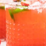 Strawberry Puree margarita in a glass with jalapenos.