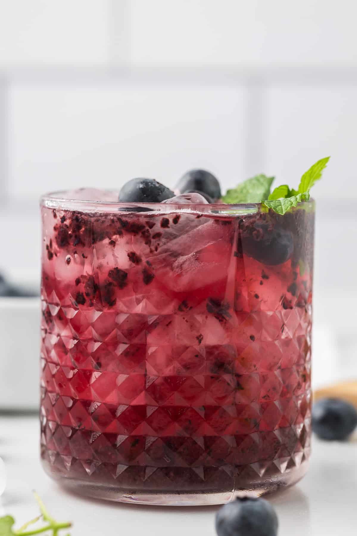 Blueberry Lemonade Vodka cocktail with blueberries and mint as garnish.