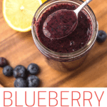 Blueberry Puree in a mason jar with lemon and blueberries scattered.