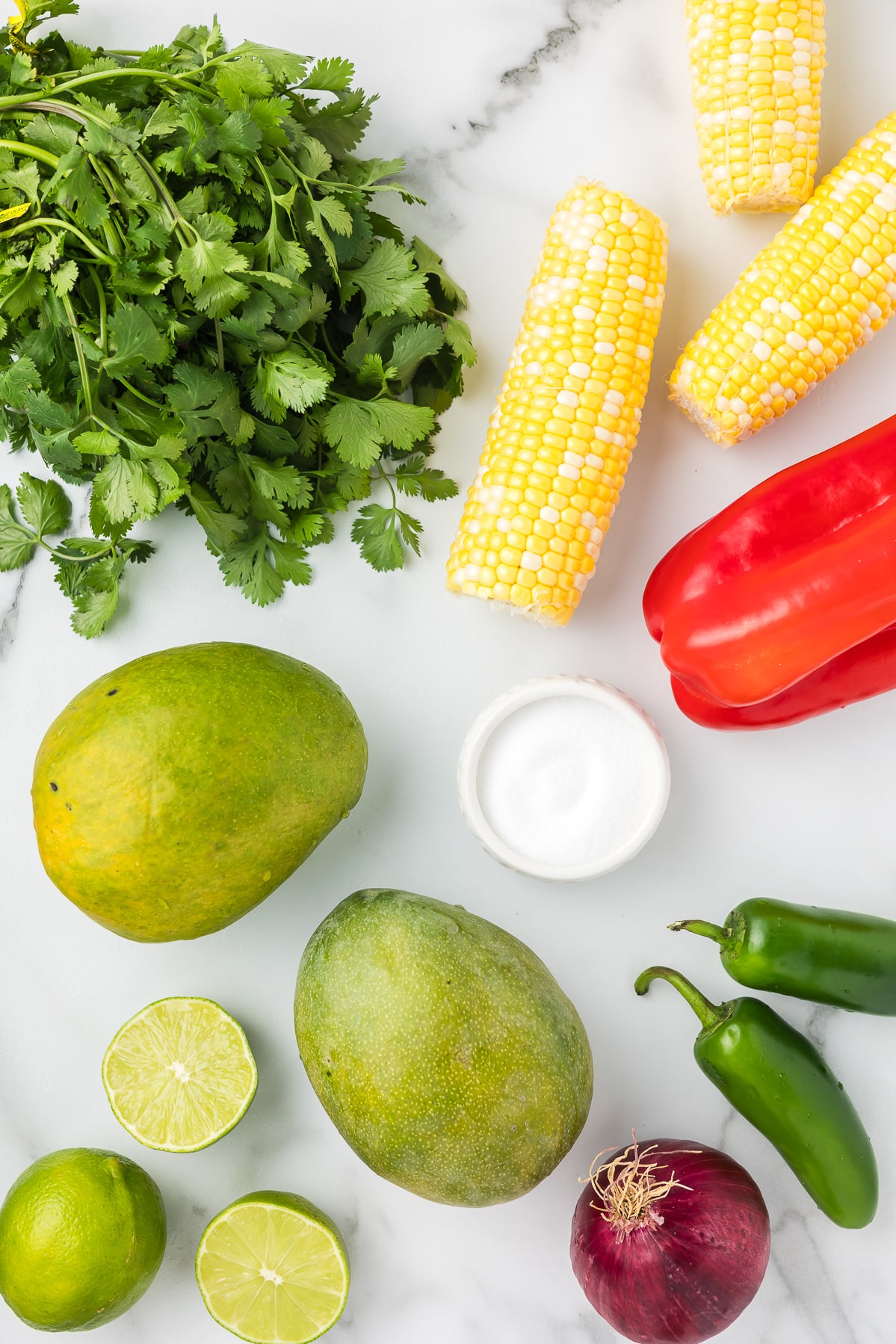 Ingredients to make mango salsa with corn.