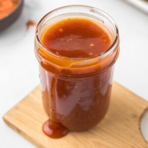 Honey Bourbon BBQ Sauce in a small mason jar.