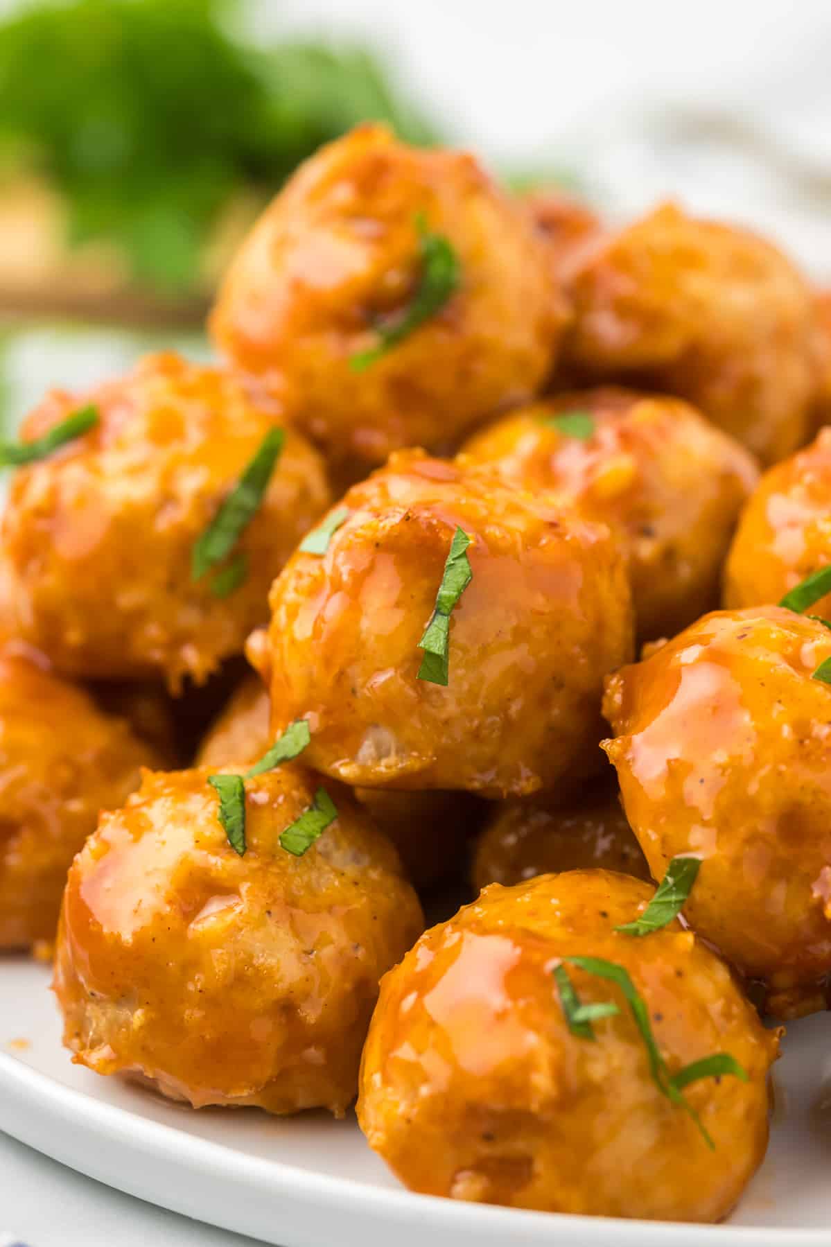 Honey Bourbon Meatballs on a plate with fresh parsley.