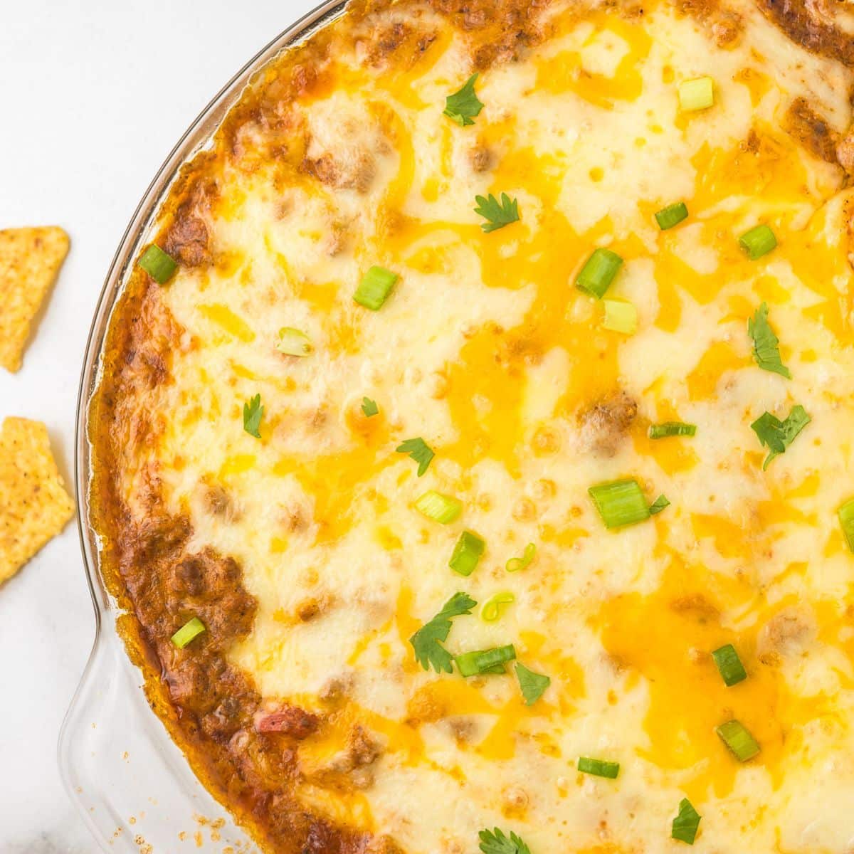 Hot Taco Dip with Cottage Cheese in a pie pan with chips.