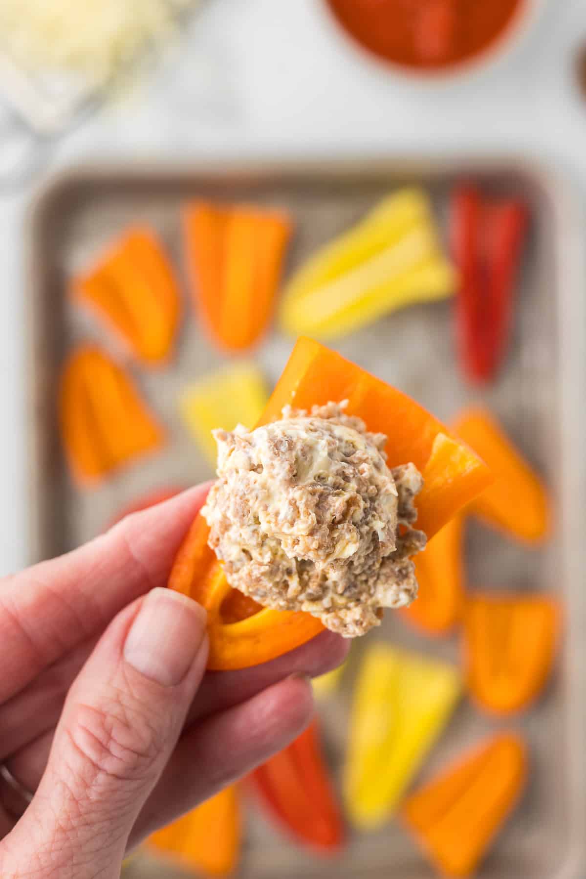 A pepper with cream cheese sausage mixture before stuffing.