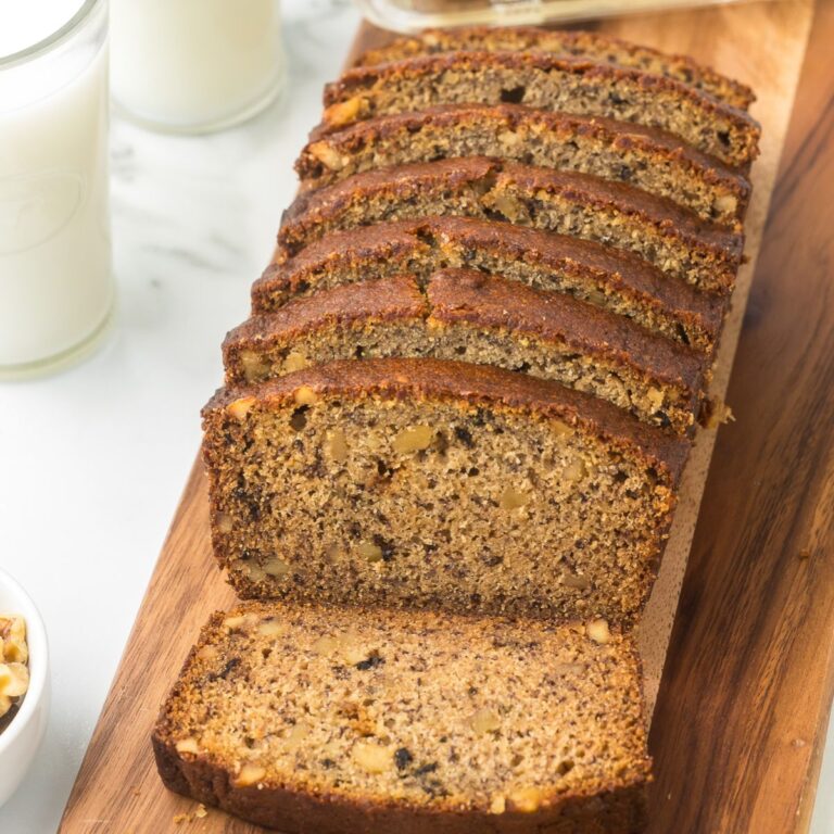 Sliced banana bread arranged on a cutting board showing the texture inside.