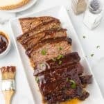 Cheesy Meatloaf with BBQ Sauce on a platter with a bbq sauce glaze on top.