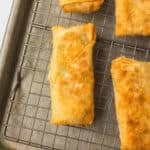 Crab Rangoon Egg Rolls on a cooling rack.