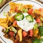 Walking Taco Bake with sour cream, tomatoes and lettuce.