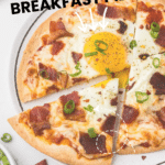 Delicious Breakfast Pizza on tortilla with cheese, sauce, bacon, and egg