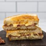 Havarti Grilled Cheese stacked on a cutting board.