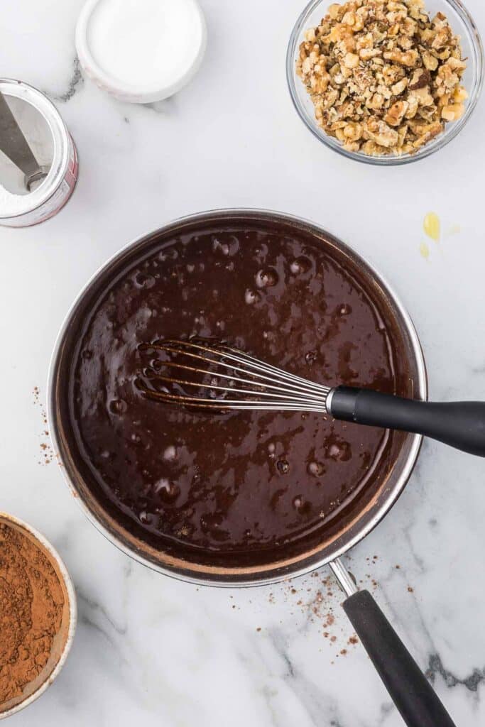 A sauce pan with brownie ingredients incorporated.