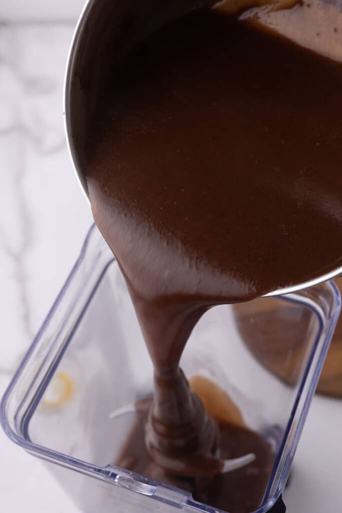 Hot fudge being poured into a blender.