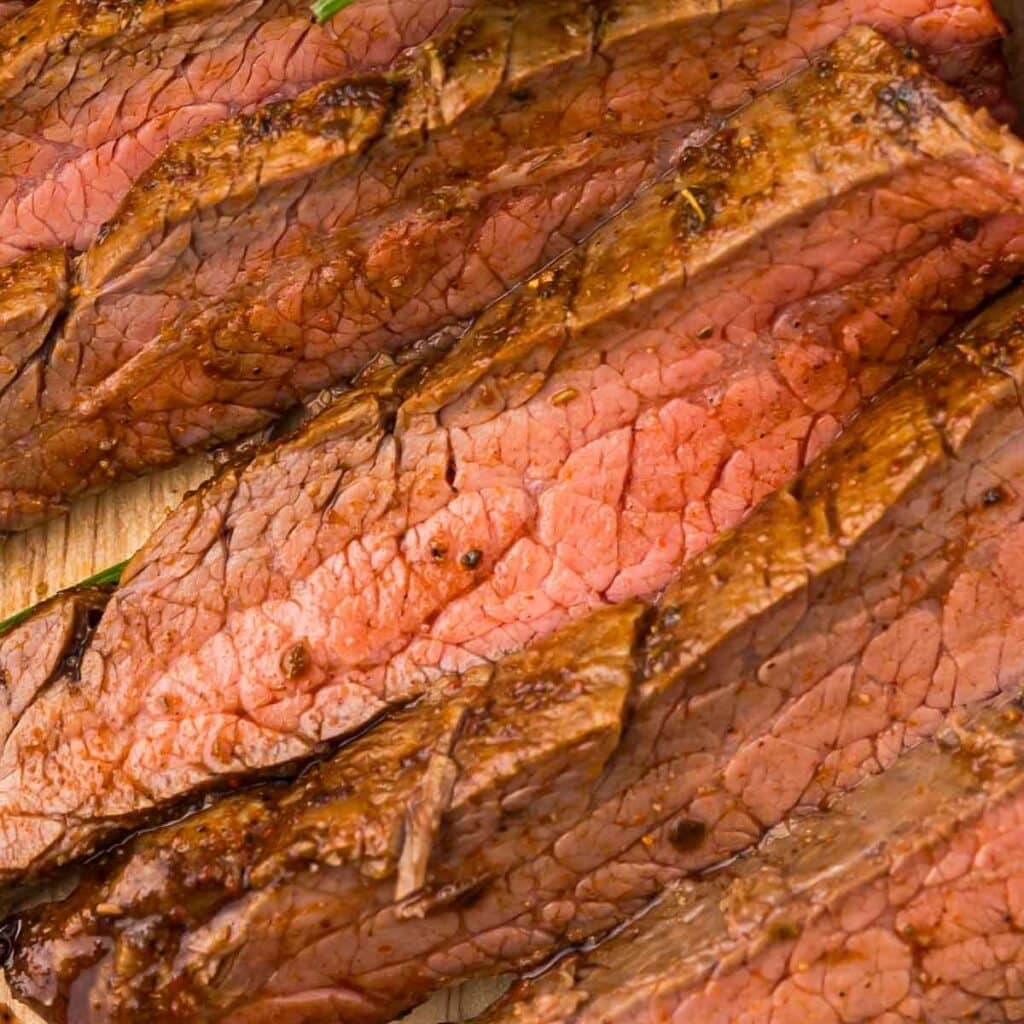 Air Fryer Flank Steak sliced on a cutting board.