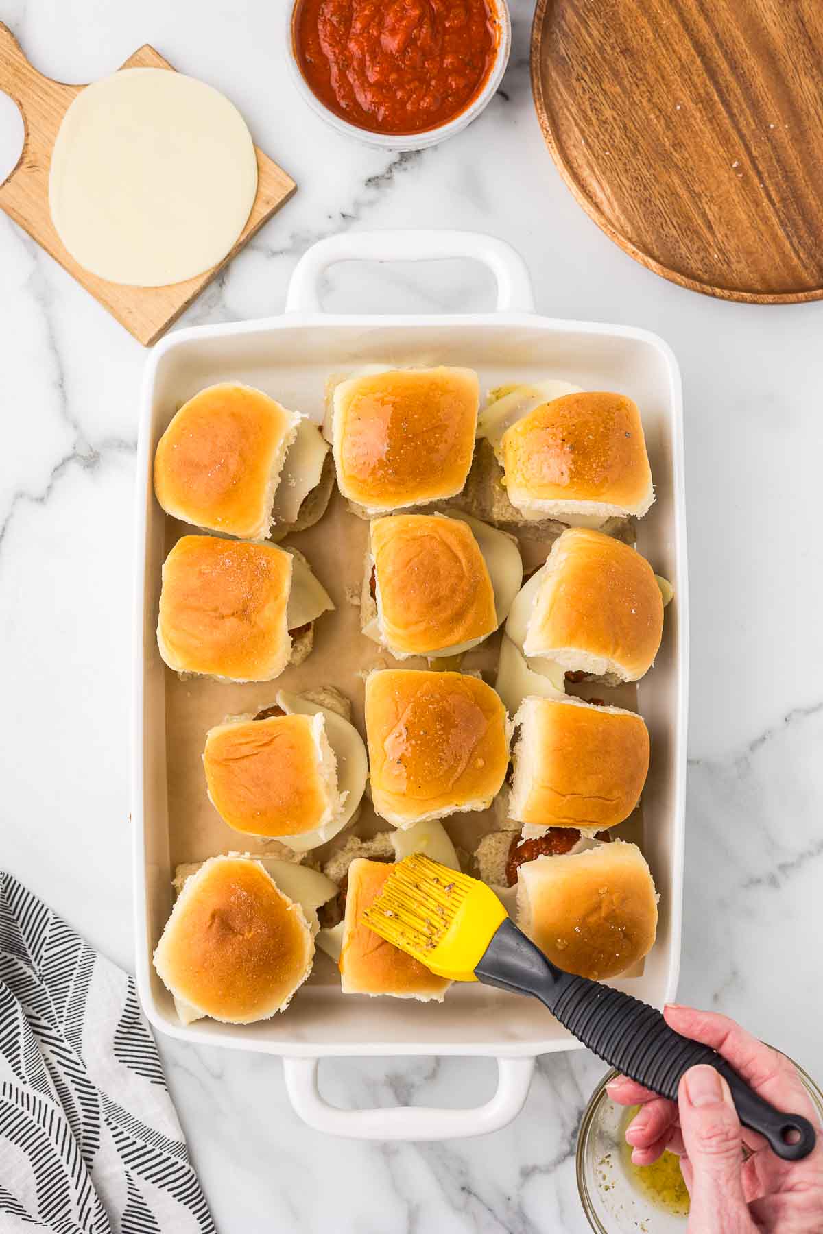 Meatball sliders in a 9 x 13 baking dish .