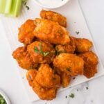 Boneless chicken wings on a plate with celery and ranch dip.