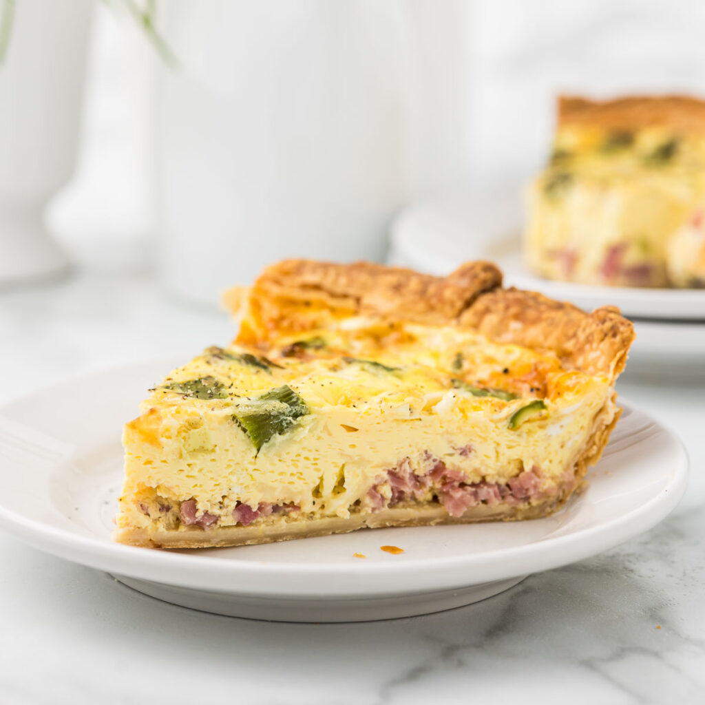 Ham quiche on a white plate.