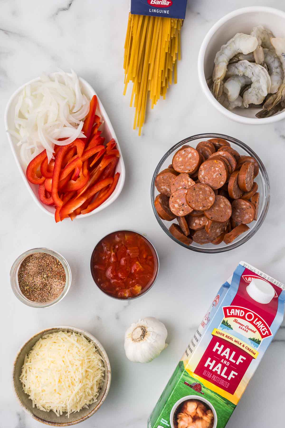 Ingredients to make creamy cajun sausage and shrimp pasta.