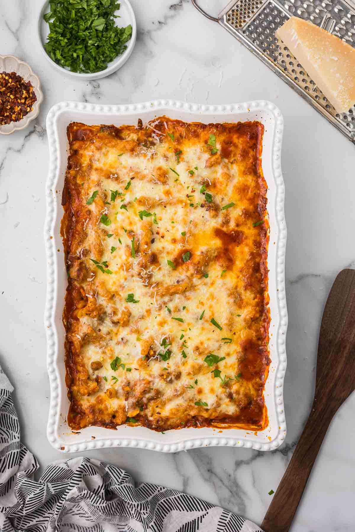 Lazy lasagna casserole in a white backing dish with parsley as garnish.