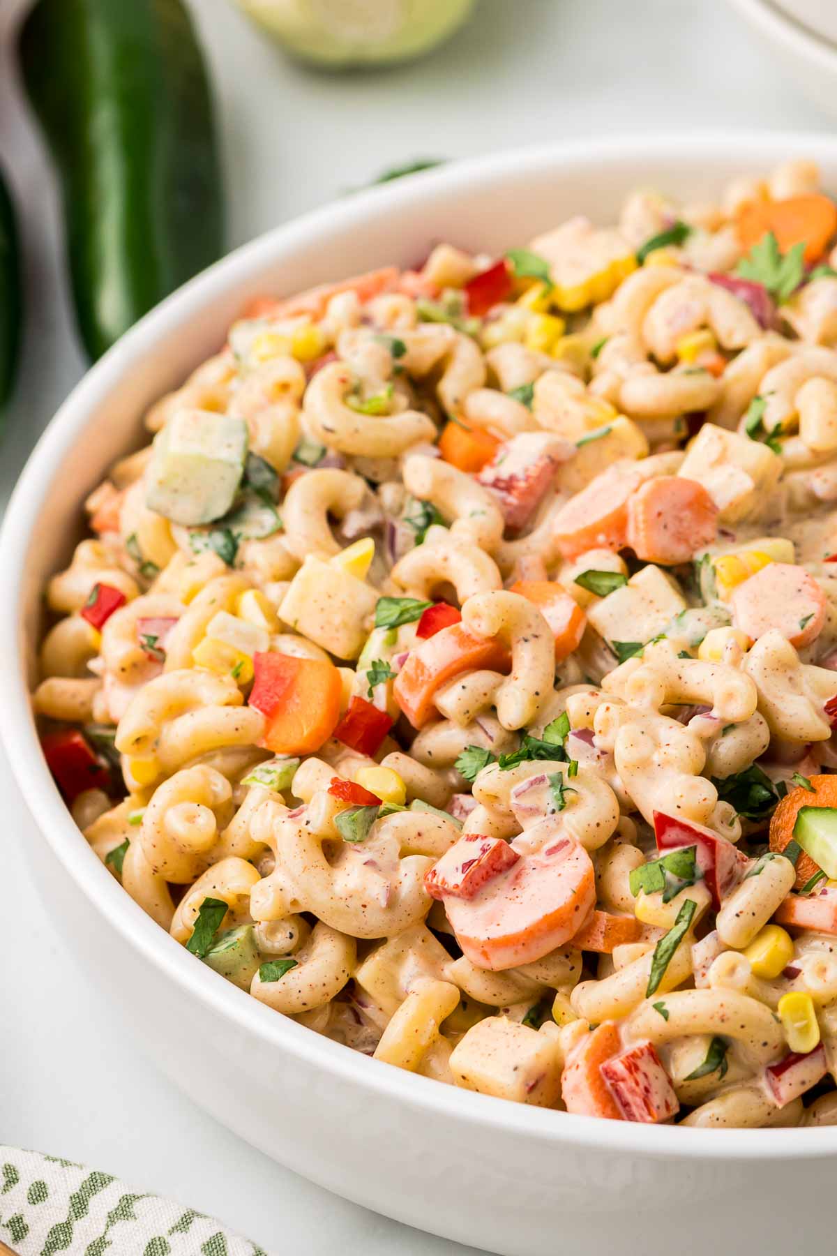 Macaroni salad in a white bowl.