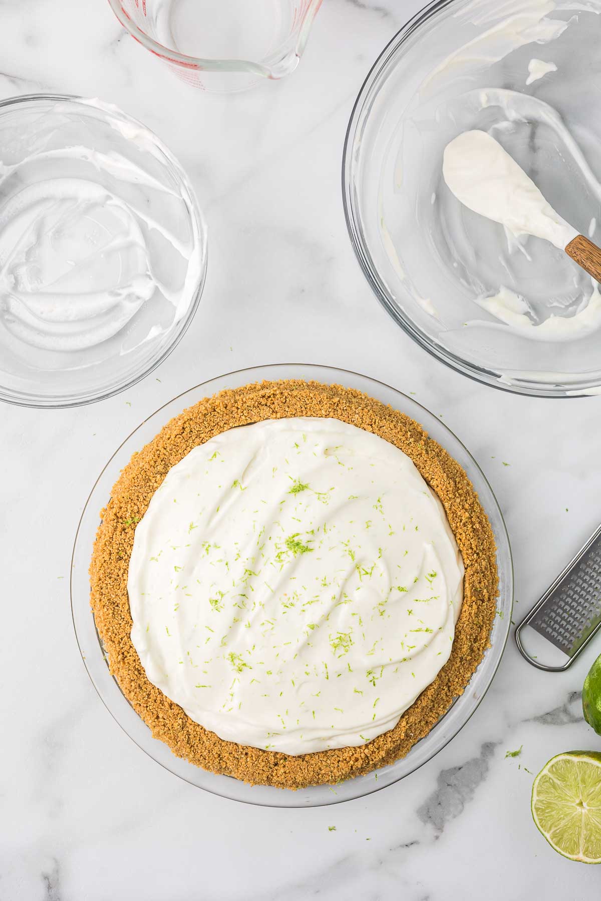Key lime pie in a homemade graham cracker crust with lime zest.