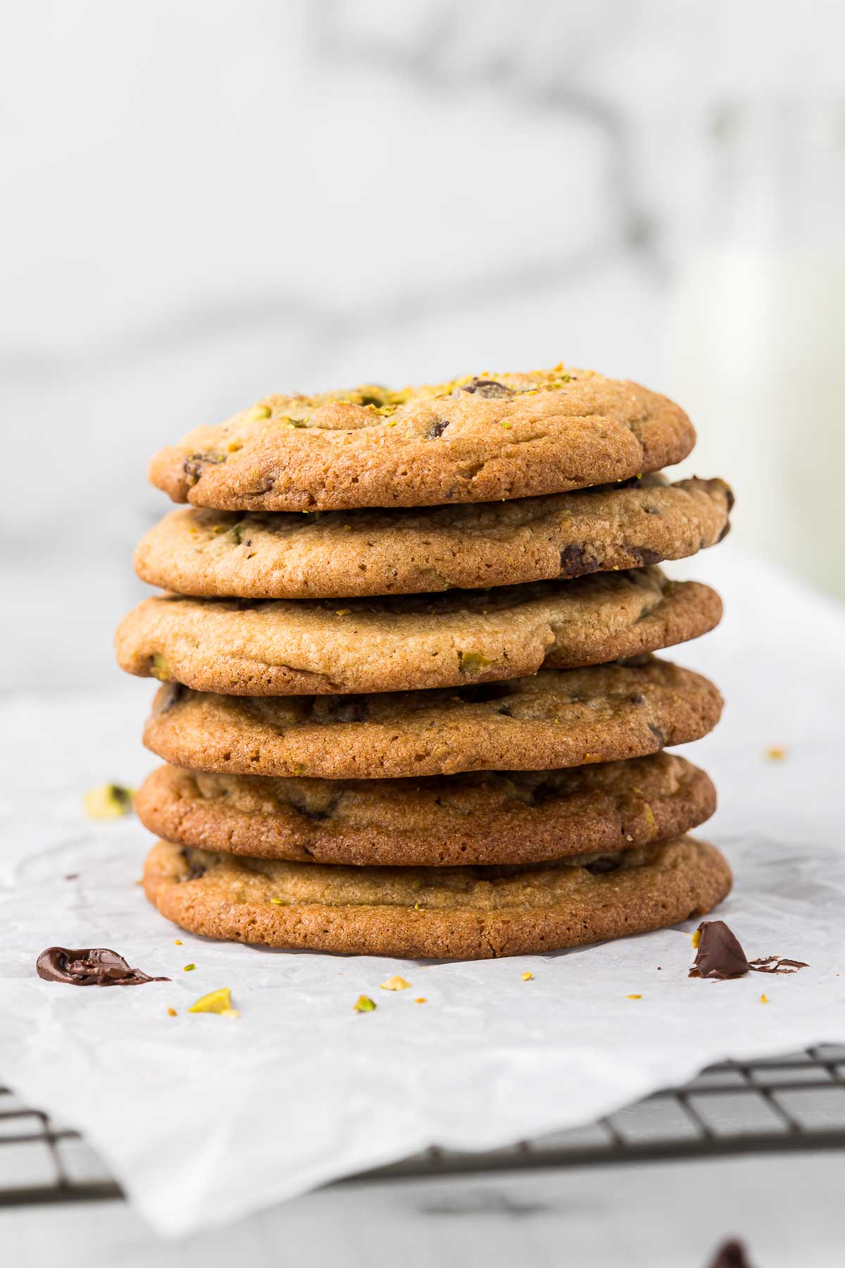 Chocolate chip cookies with pistachios in a stack.