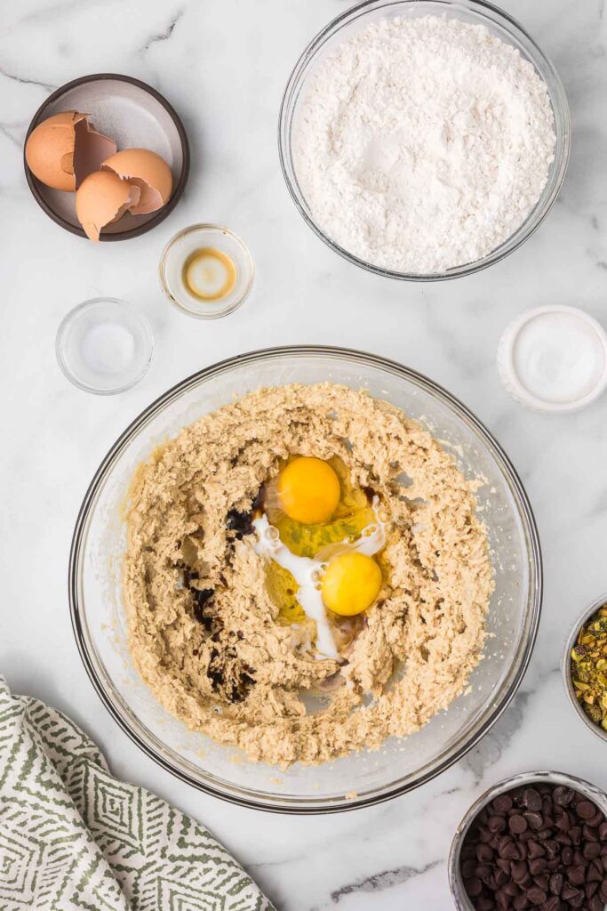 Butter and sugar beaten to make cookie dough with egg, vanilla and milk added.