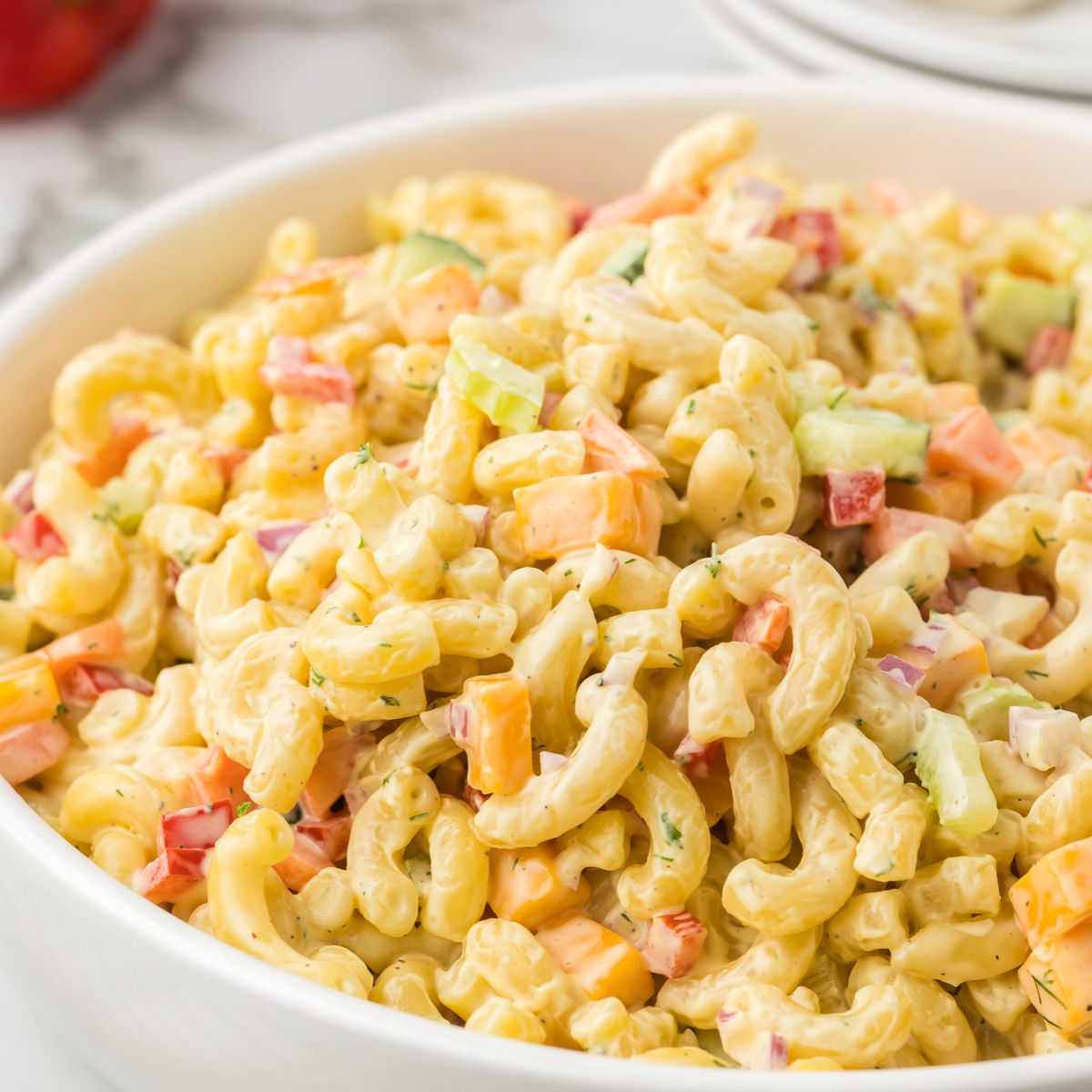 Macaroni Salad in a white serving bowl.