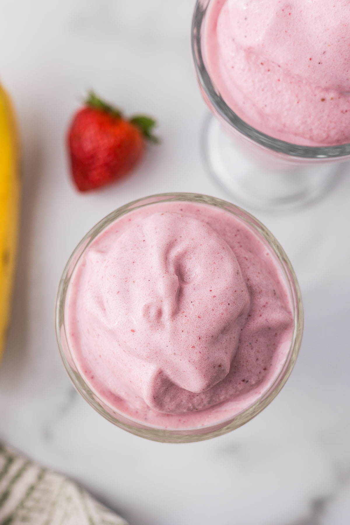 Banana strawberry smoothie in a clear glass.