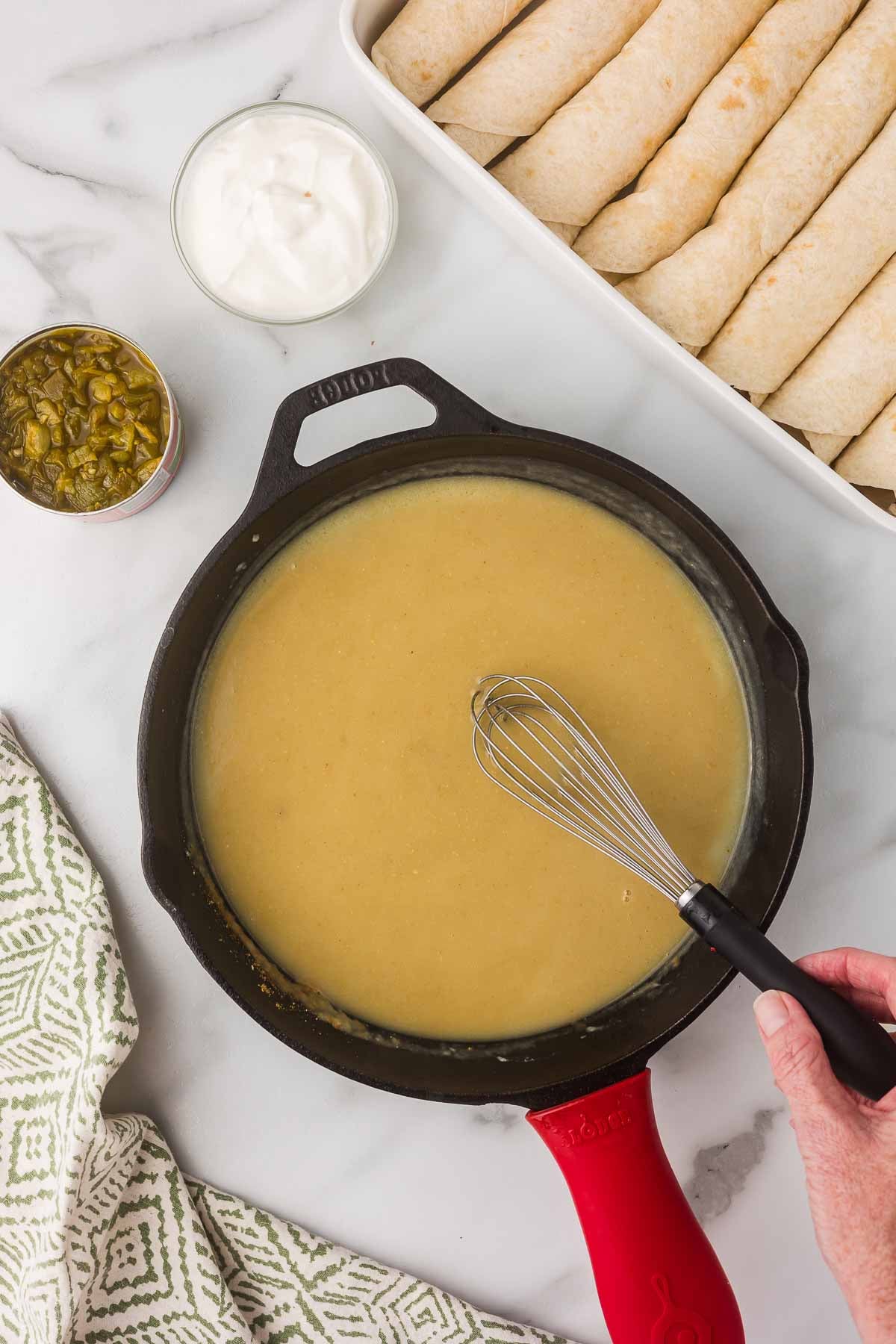 
Homemade green chile sour cream sauce for chicken enchiladas.
