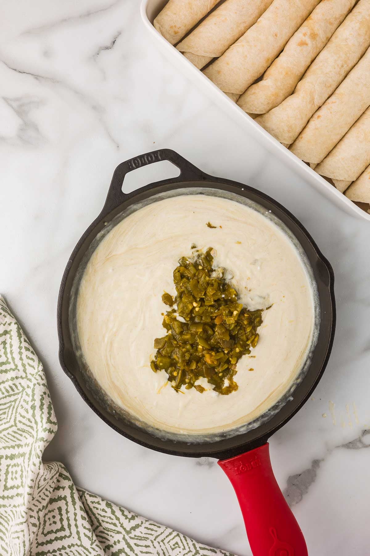 
Homemade green chile sour cream sauce for chicken enchiladas.