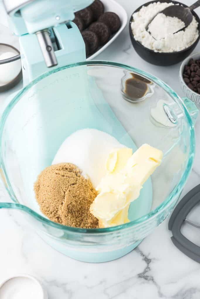 Butter, brown sugar and granulated sugar in a glass kitchen aid bowl.