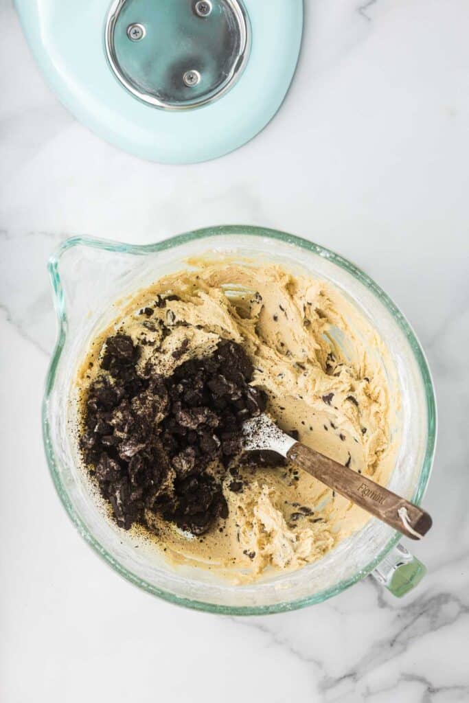 Oreo cookie dough in a glass kitchen aid bowl.