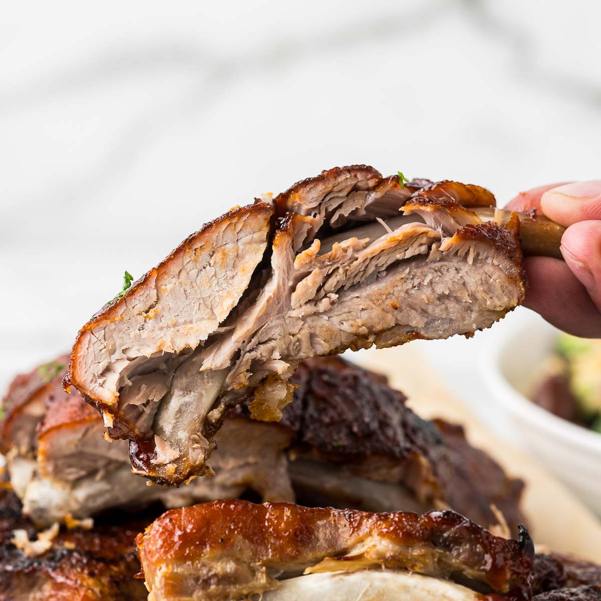 Crockpot bbq baby back ribs on a plate.