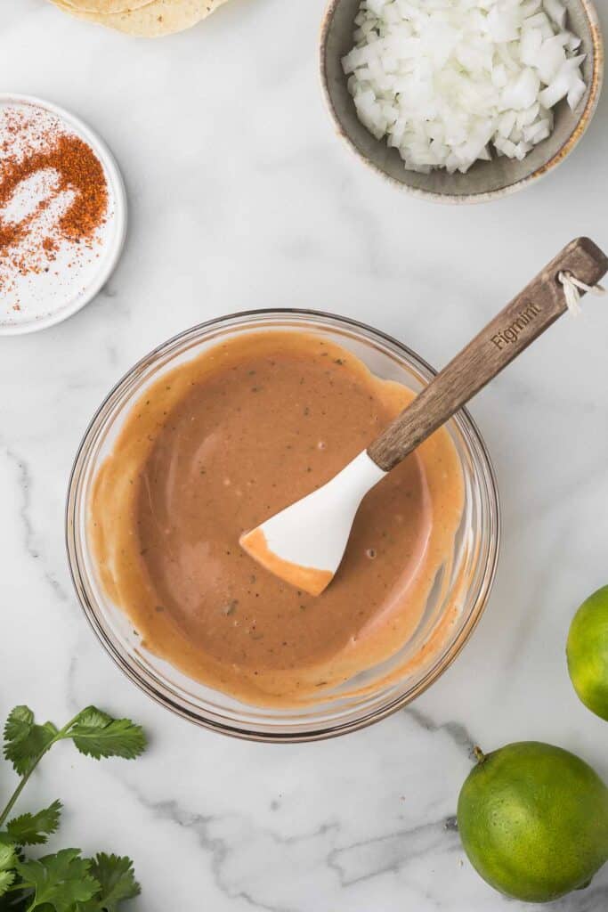 Mixed ingredients in a bowl with spatula