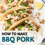 A plate of three BBQ Pork Tacos topped with shredded cheese and fresh cilantro. Lime wedges are on the side. Text overlay reads "How to Make BBQ Pork Tacos" with a blog name at the bottom.