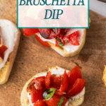 Top view of bruschetta dip on a wooden board. Slices of bread are topped with diced tomatoes, basil, and a creamy spread. Text overlay reads "Homemade Bruschetta Dip" and "cookingupmemories.com".