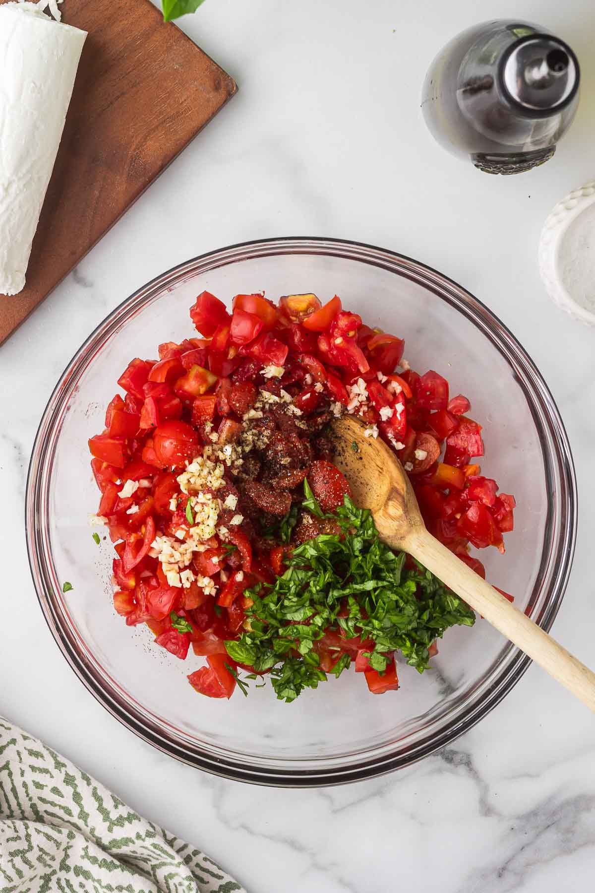 chopped basil, olive oil, and balsamic vinegar to the tomato mixture