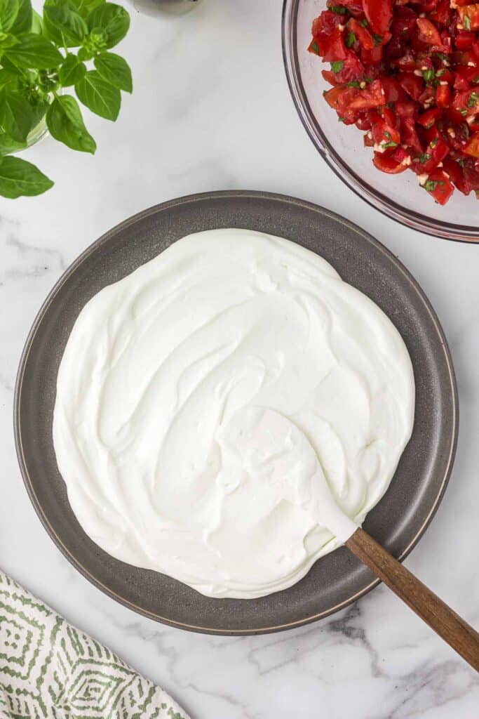 Whipped goat cheese on serving plate