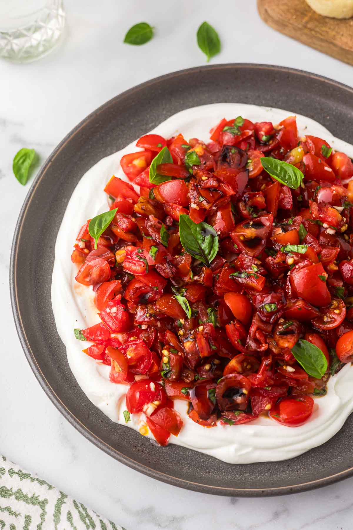 Bruschetta Dip on a gray plate with fresh basil.