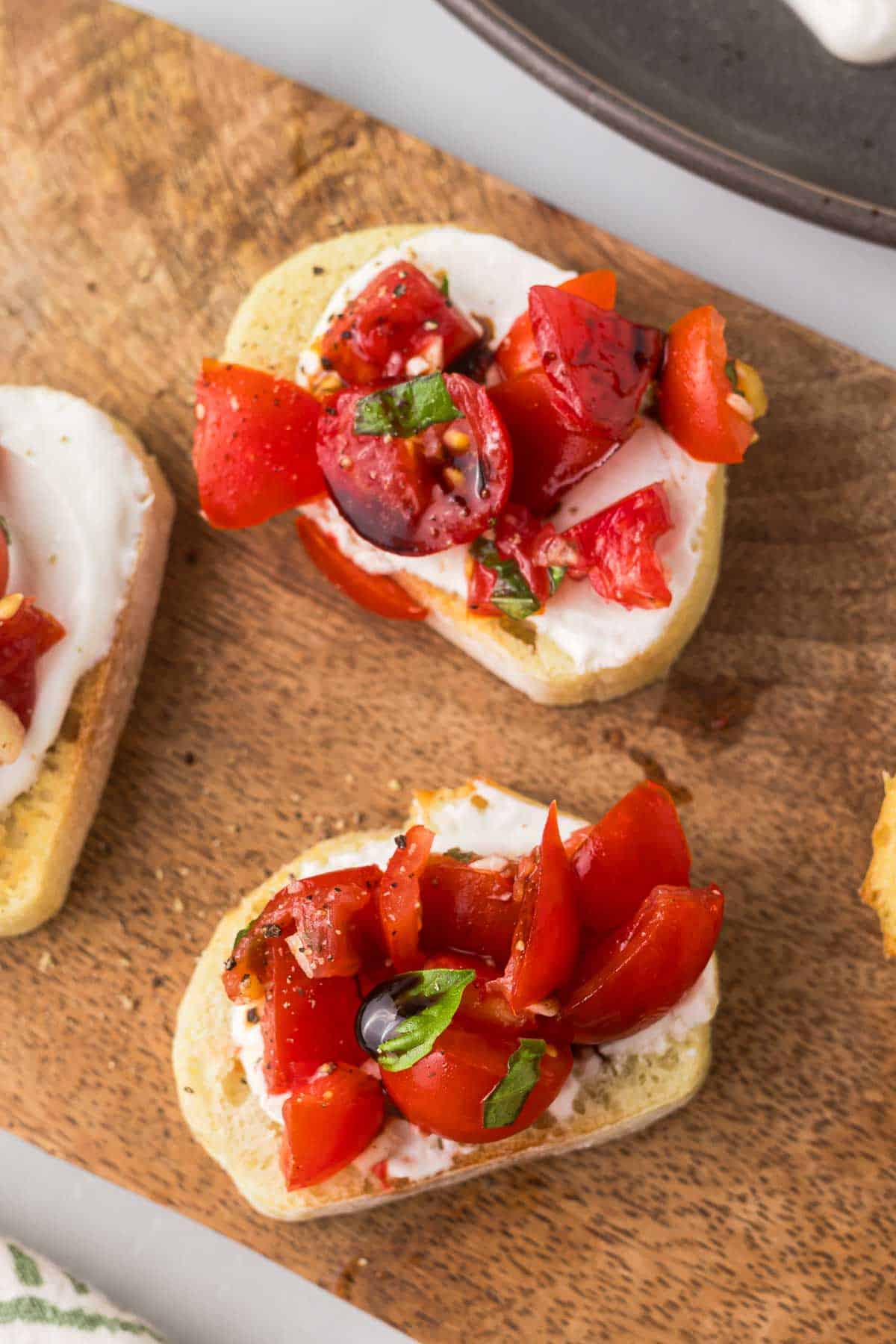 chopped basil, olive oil, and balsamic vinegar to the tomato mixture and whipped goat cheese on bread