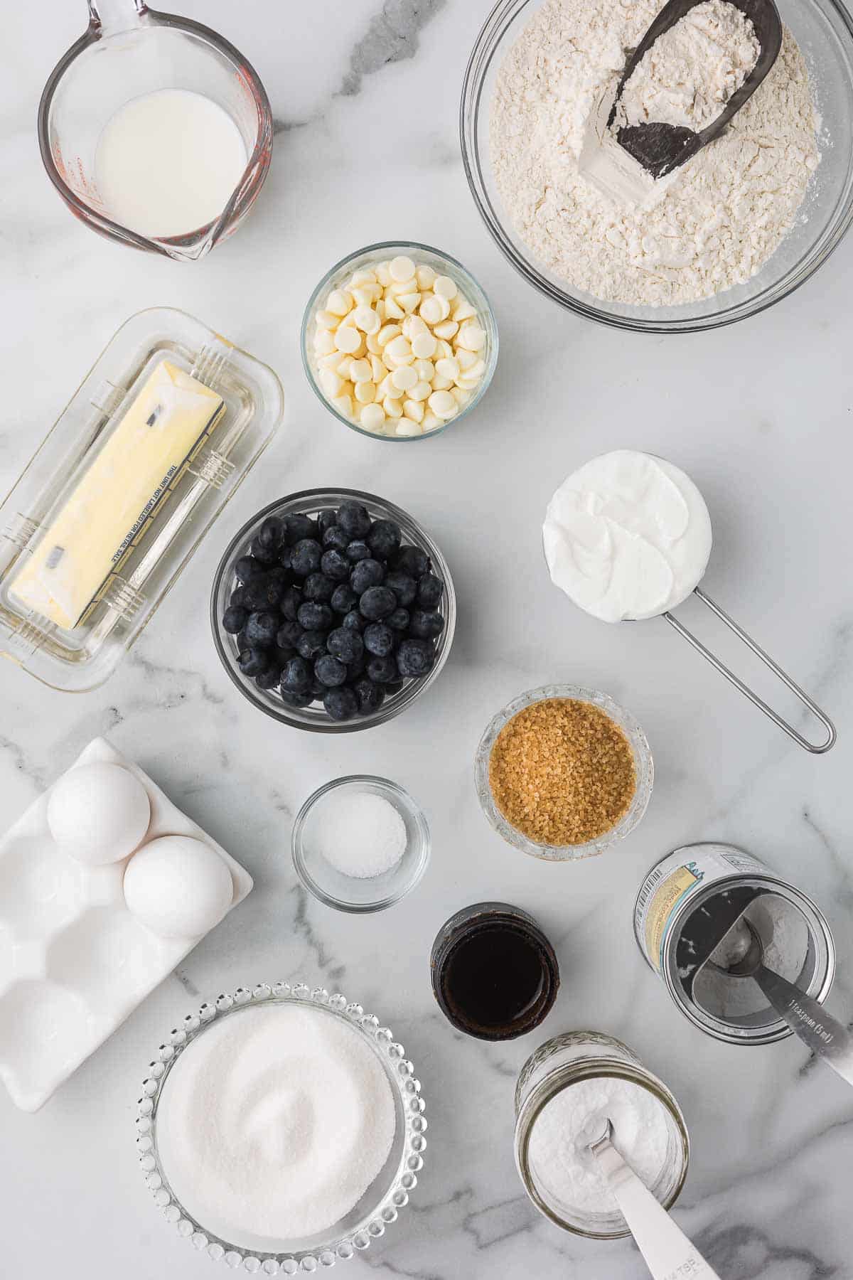 Ingredients to make blue berry muffins with white chocolate chips.