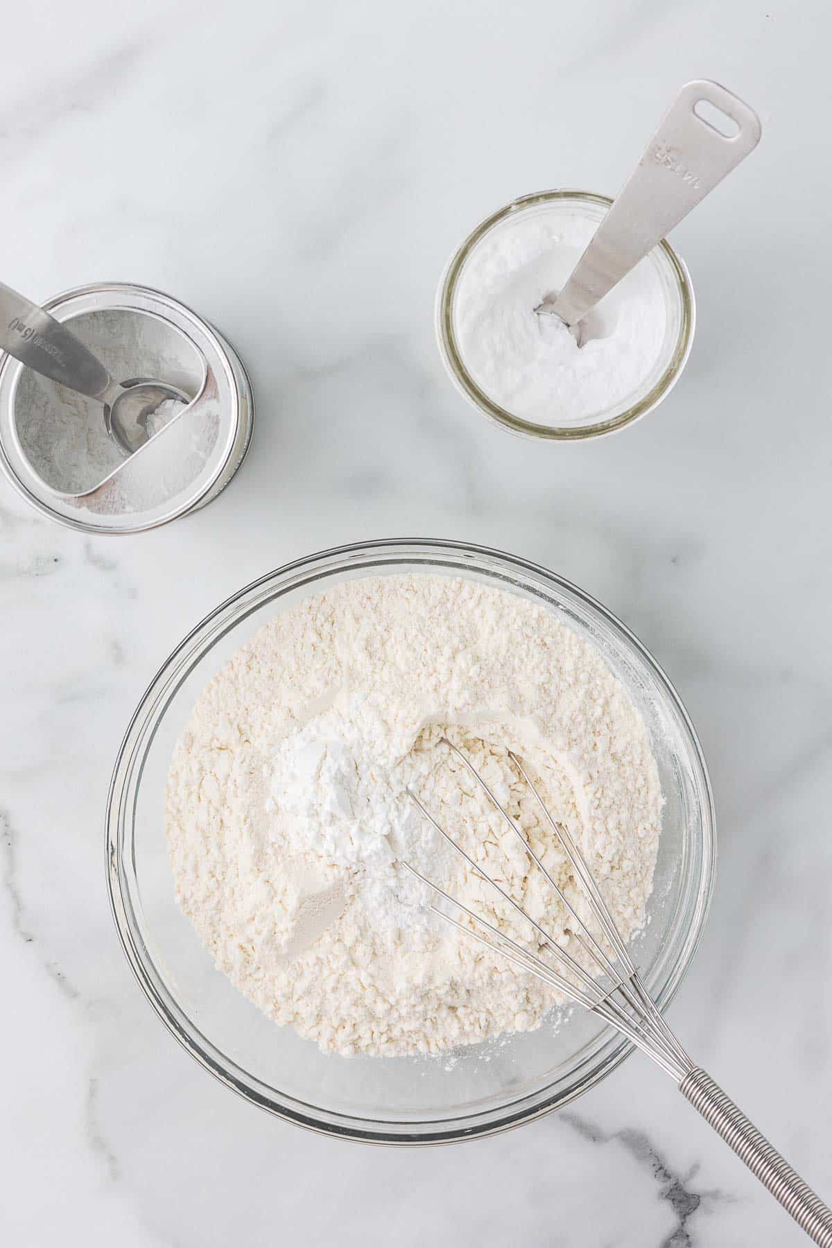 Flour, salt, baking soda and baking powder in a small bowl with a whisk.