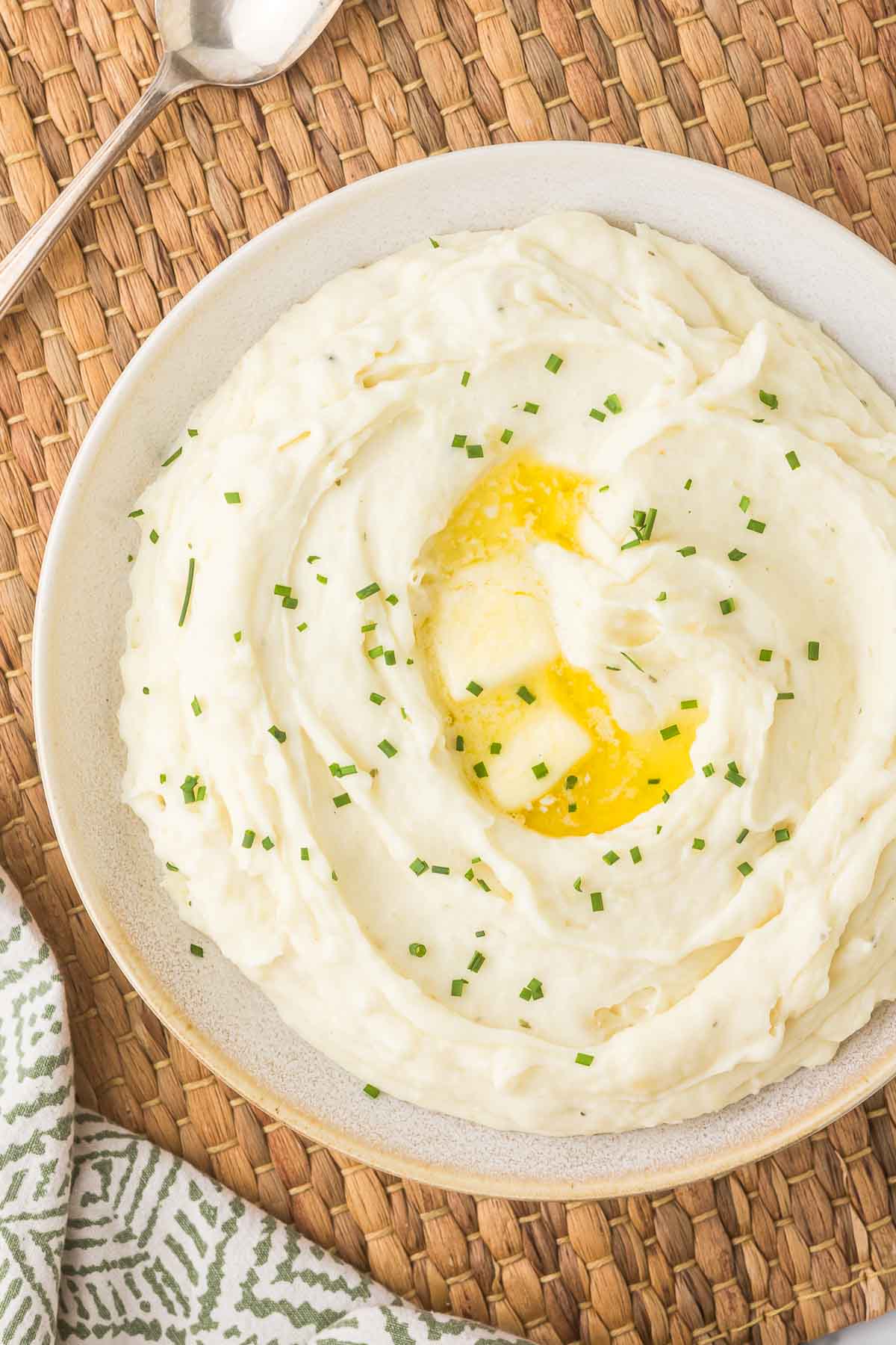 Boursin Mashed Potatoes with butter pooled on top.