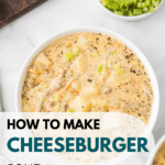 A bowl of savory cheeseburger soup garnished with vibrant green onions sits invitingly. Nearby, a slice of bread rests on a wooden board beside a small bowl of additional chopped onions. The text overlay reads "How to make cheeseburger soup." Explore more at cookingupmemories.com.