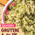 A bowl of savory Gruyere and olive party dip garnished with chopped green onions. The text reads "Savory Gruyere & Olive Party Dip" and the website "cookingupmemories.com" is displayed at the top. Slices of bread are in the background.