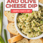 A bowl of Gruyere and olive cheese dip surrounded by slices of baguette on a wooden board. Green onions are arranged beside the board. Text overlay reads, "Ultimate Gruyere and Olive Cheese Dip - Simple Party Dip.